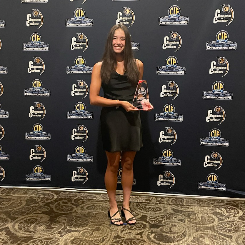 Mika Ikemori holding up her CIF Champions for Character Award